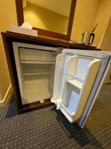 an empty refrigerator with its door open in a room at Al Maqam Alsharqy Shuttle Srevice to Haram in Mecca