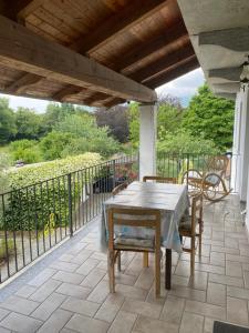 a patio with a table and chairs on a balcony at La Cà di Carol Apartment in Andorno Micca