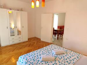 a bedroom with a bed with two towels on it at Apartment Mila in Primošten