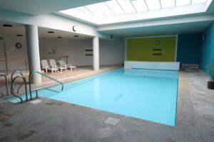 a large swimming pool in a large room at Ghent Business Flat in Ghent