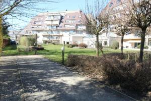 a large apartment building with a park in front of it at Ghent Business Flat in Ghent