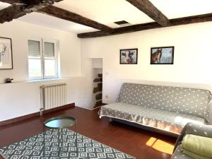 a living room with a couch and a table at Casas da Loureira in Gondarém +148 photos