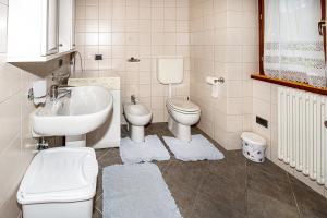 a bathroom with a sink and a toilet and a sink at Fausta Lago in Colico