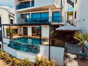 an image of a house with a swimming pool at Villa Alpha Familiare in Prizren