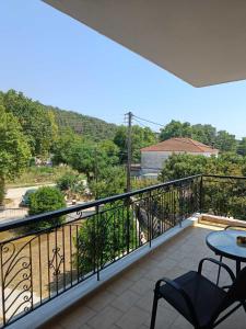 a balcony with a table and chairs and a view at Villa Orfani in Orfánion