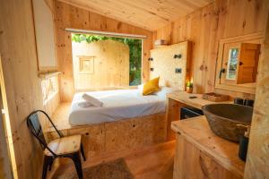 a bedroom in a log cabin with a bed in it at Kampaoh Playa de Levante in Benidorm
