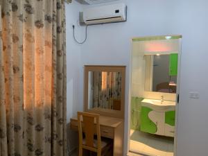 a bathroom with a sink and a mirror at Montazah Residence in Dar el Koudia +9 photos