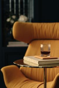 a coffee table with a book and a glass on it at Beau-Rivage Nyon in Nyon