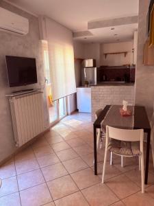 a kitchen and dining room with a table and chairs at La Terrazza in Civitavecchia