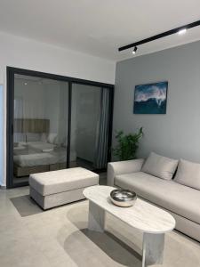a living room with a couch and a table at Appartement Cassia Vue Piscine rénovée cette année in Cabo Negro
