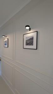 a white wall with two pictures on it at FREISTIEL 4 in Hattenheim