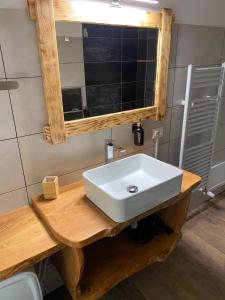 a bathroom with a white sink and a mirror at Fuga dalla città in Aidone