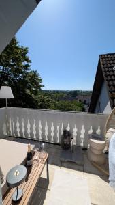 a balcony with a white fence and a table at FREISTIEL 4 in Hattenheim +38 photos