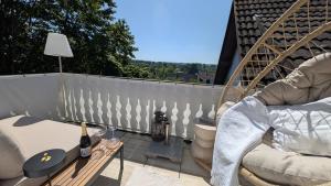 a balcony with a chair and a table with a lamp at FREISTIEL 4 in Hattenheim