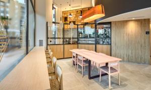 a dining room with a table and chairs at Sercotel Rosaleda Málaga in Málaga +32 photos