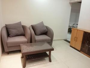 a living room with a couch and a coffee table at 3BHk flat family friendly in Raipur +2 photos