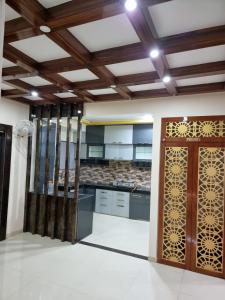 a kitchen with a wooden door in a room at 3BHk flat family friendly in Raipur