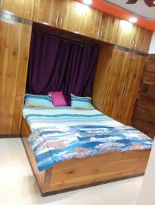 a bed in a room with a window at 3BHk flat family friendly in Raipur