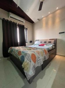 a bedroom with a bed with a quilt on it at 3BHk flat family friendly in Raipur