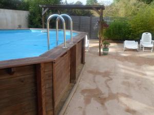 a swimming pool with metal bars on the side of it at Les Cerisiers Gîtes in Lezay