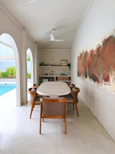 a dining room with a table and chairs at The Suite by Ceilao Villas in Ahangama