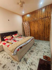 a bedroom with a bed with a wooden wall at Om Homestay in Panchkula