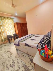 a bedroom with a bed with a basket on a table at Om Homestay in Panchkula
