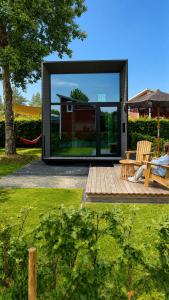 a person sitting on a bench in a house at EMSLAND-CAMP in Haar
