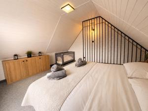a bedroom with a large bed with two pillows on it at Resort Eden Premium Domki Jacuzzi, sauna in Jastrzębia Góra