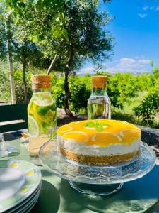 a cake sitting on a table with two bottles at Zagara Suite in Francofonte +29 photos