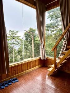 a room with a large window and a wooden floor at Dốc Mơ Homestay in Bản Bé +31 photos