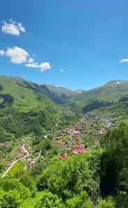 a valley in the mountains with houses and trees at Hamsiköy Doruk Apart in Macka