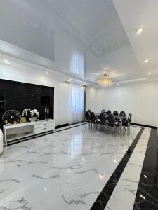 a dining room with a table and chairs on a marble floor at Events house With Swimming Pool in Agarak +16 photos
