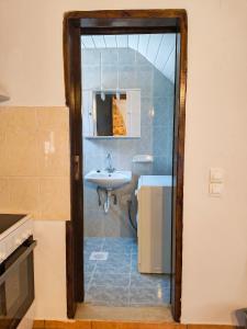 a bathroom with a sink and a white sink at Sofia Apartments- Melidoni in Melidhónion +27 photos
