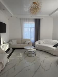 a white living room with a couch and a table at Events house With Swimming Pool in Agarak