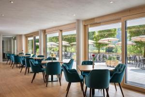 a restaurant with tables and chairs and windows at Hotel Prinz-Luitpold-Bad in Bad Hindelang