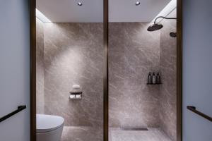 a shower with a glass door in a bathroom at Mercure Beijing Lize Road in Beijing +27 photos