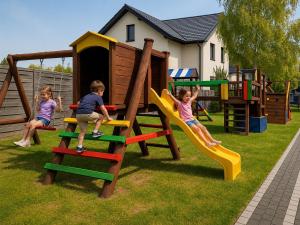 a group of children playing on a playground at Resort Eden Premium Domki Jacuzzi, sauna in Jastrzębia Góra