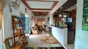 a room with a kitchen and a living room at Pina Colina Resort Tagaytay City by RedDoorz in Tagaytay