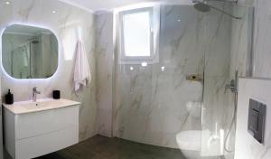 a bathroom with a shower and a sink and a toilet at Kassiani Studios in Keramoti +87 photos