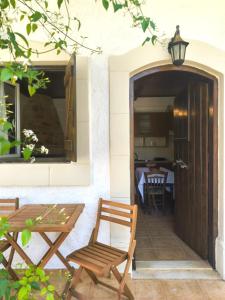 a patio with a table and chairs and a table at Sofia Apartments- Melidoni in Melidhónion