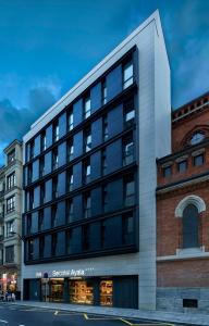a large building on the corner of a street at Sercotel Ayala in Bilbao +26 photos