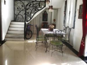 a dining room with a table and chairs and stairs at The Mulberry Villa kandy in Kandy +37 photos