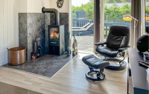 a living room with two chairs and a fireplace at 3 Bedroom Nice Home In Hals in Hals
