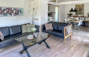 a living room with a couch and a table at 3 Bedroom Nice Home In Hals in Hals