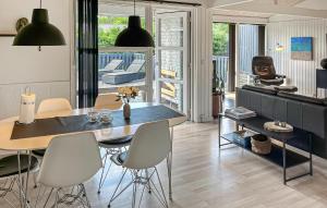 a living room with a dining room table and chairs at 3 Bedroom Nice Home In Hals in Hals