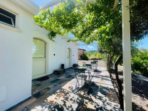 a patio with chairs and a table in a house at Zagara Suite in Francofonte