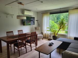 a living room with a table and chairs and a couch at Old village school in Kolkontaipale