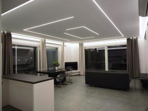 a living room with a table and some windows at Kassiani Studios in Keramoti