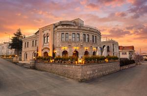 a large building with lights in front of it at Grand Cappadocia Hotel in Göreme